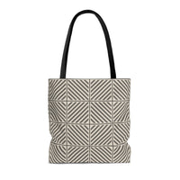 Photo of a neutral colored tote bag with a pattern of intersecting and repeating lines. This neutral tote is in colors of greige, tan and stone brown.