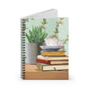 Gift for booklovers. Spiral notebook with teacup on book stack with succulent plant in background.
