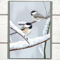 Photo shows a bird holiday card featuring two chickadees sitting on snowy branches. A non-denominational holiday card that is also perfect as a Christmas card.