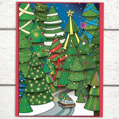 winter holiday cards, Photo shows a Whimsical Holiday card with a wood paneled station wagon driving a fully decorated tree through a forest of lit trees, forest christmas cards