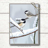 Photo shows a bird holiday card boxed set featuring two chickadees sitting on snowy branches. A non-denominational holiday card that is also perfect as a Christmas card.