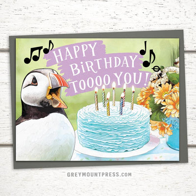 happy birthday cards, Puffin birthday card, Happy birthday card featuring a puffin singing happy birthday to you in front of cake and flowers, funny birthday cards for friends